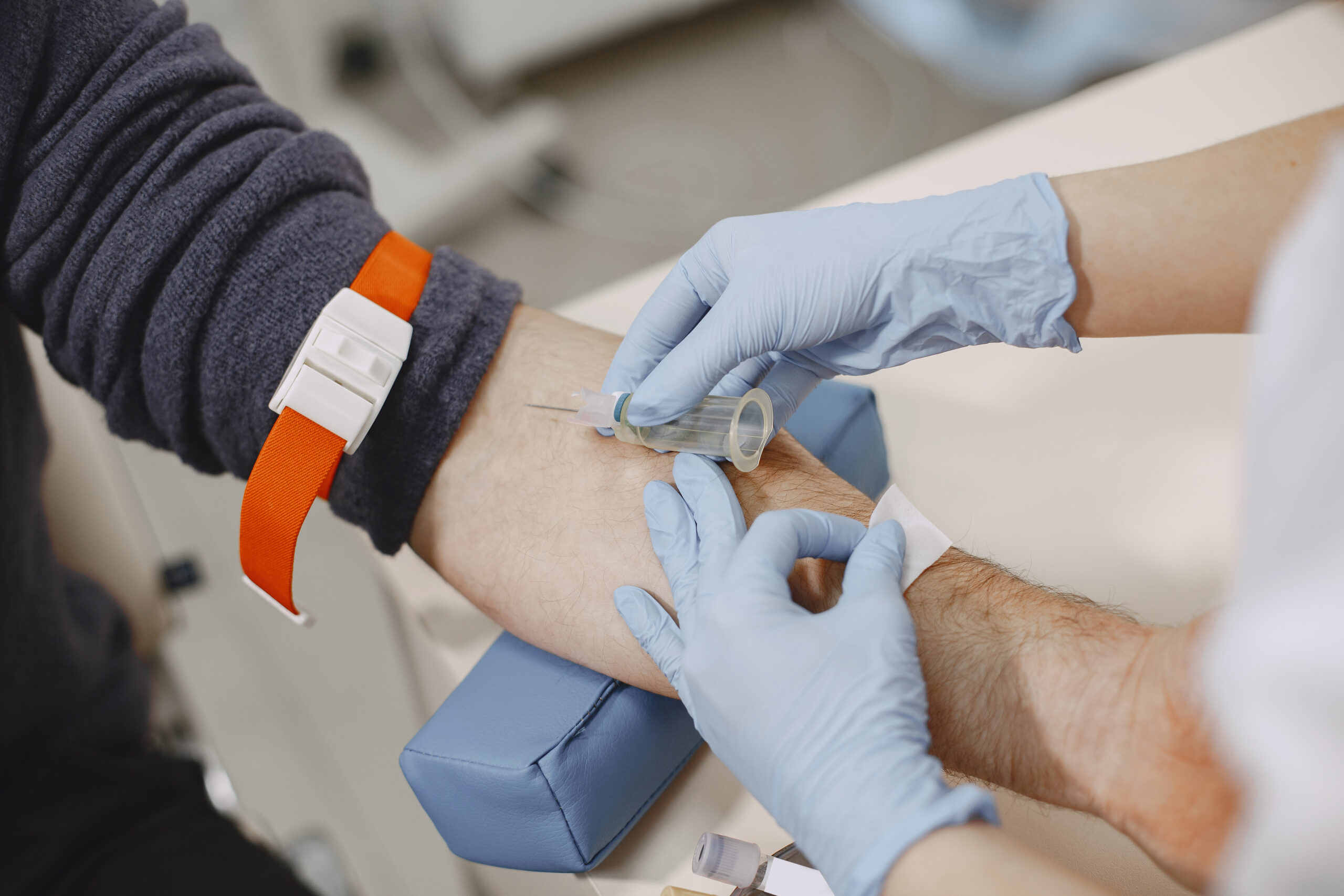 skillful-nurse-is-doing-blood-test-man-clinic-man-medical-mask-scaled.jpg