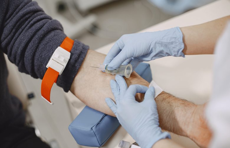 skillful-nurse-is-doing-blood-test-man-clinic-man-medical-mask-scaled.jpg