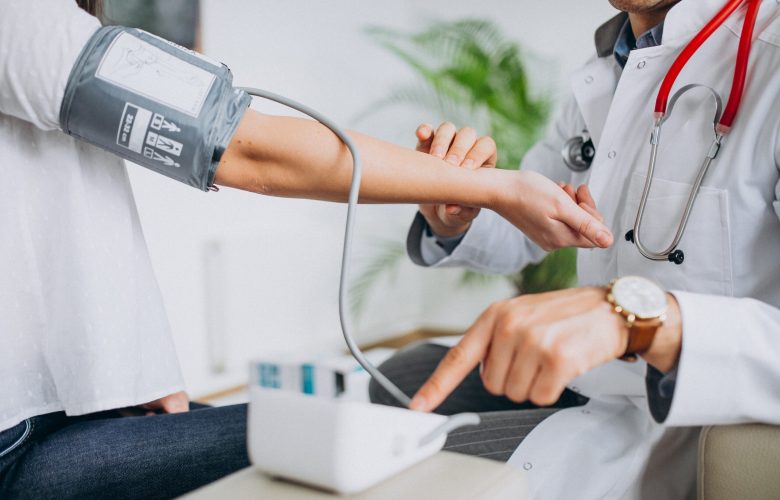 young-male-psysician-with-patient-measuring-blood-pressure-scaled.jpg